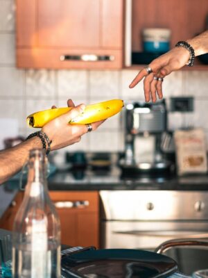 A Man Sharing A Ripe Banana